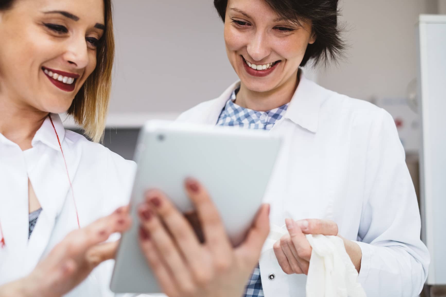 Two doctors using tablet computer while working in the lab